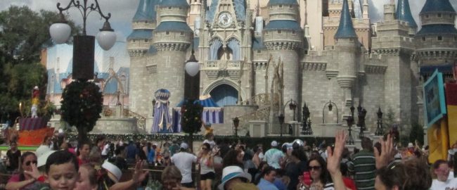 Crowds at the Hub in front of Magic Kingdom's Cinderella Castle.