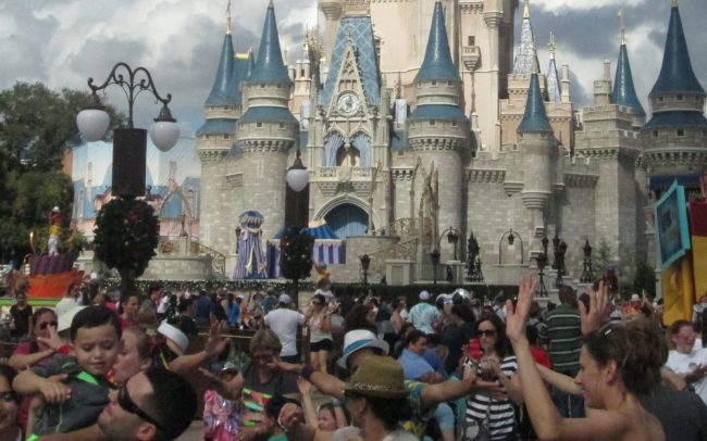 Crowds at the Hub in front of Magic Kingdom's Cinderella Castle.