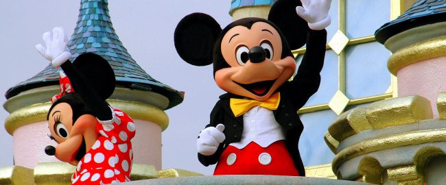 Mickey and Minnie wave to the crowds. Photo source Depositphotos_69250695_original.jpg.