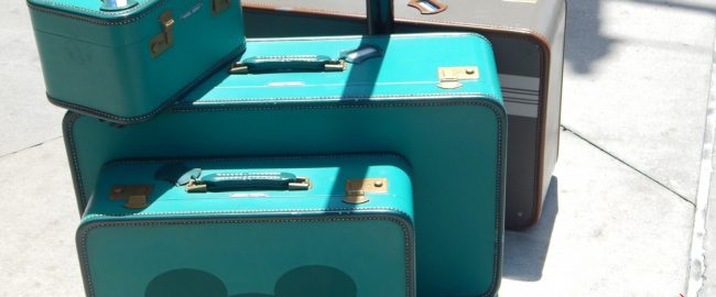 Some suitcases, one of which has a Mickey silhouette on it.