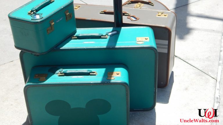 Some suitcases, one of which has a Mickey silhouette on it.
