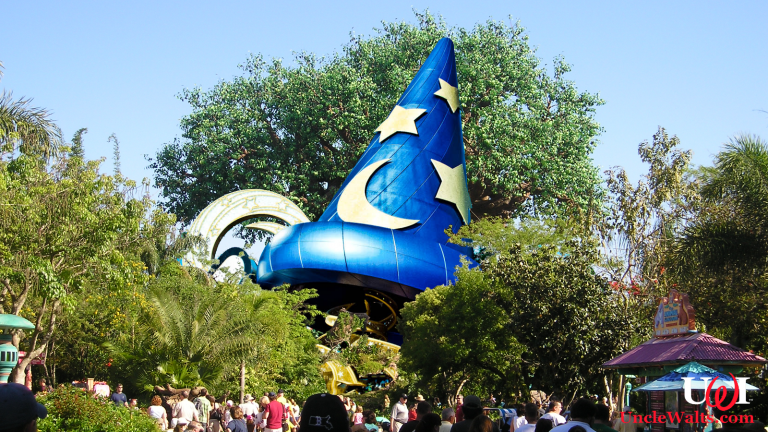 The Sorceror Mickey Hat in its new Animal Kingdom home. Photo credit Mfwills [CC BY-SA 3.0] via Wikimedia Commons and Katie Harbath [CC BY-NC-SA 2.0] via Flikr.