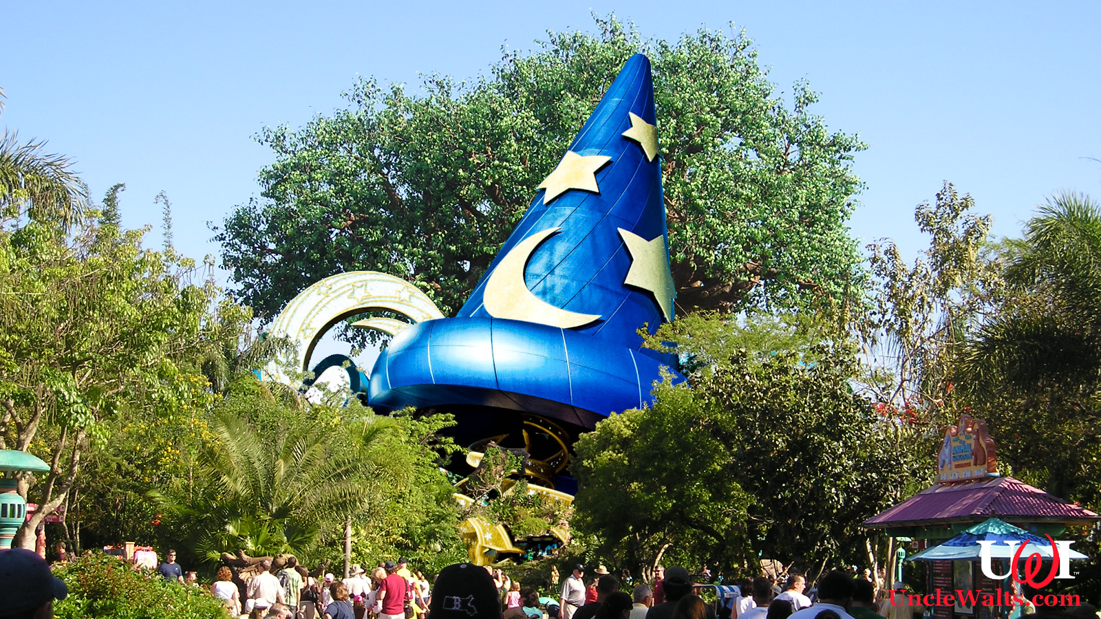 The Sorceror Mickey Hat in its new Animal Kingdom home. Photo credit Mfwills [CC BY-SA 3.0] via Wikimedia Commons and Katie Harbath [CC BY-NC-SA 2.0] via Flikr.
