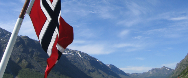 Norway (we presume) with a Norwegian flag flying. Photo by mroach [CC BY-SA 2.0] via Flickr.