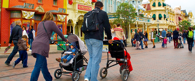 A family walks down Main Street with two non-rented children. Photo by DepositPhotos.