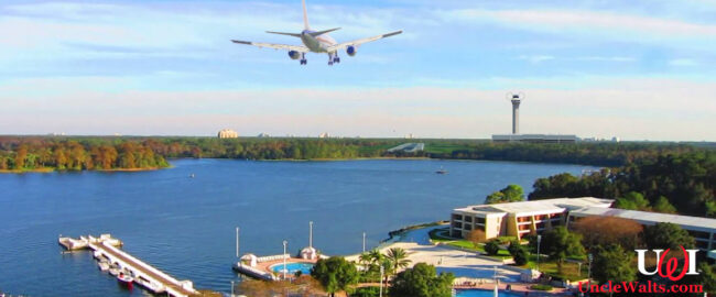 A passenger jet on final approach over Bay Lake, as seen from the Contemporary Hotel. Photo by Mike Belobradic via YouTube, TheMightyQuill [CC BY 2.0] via Flickr, and maybe a couple of others. We lose track.